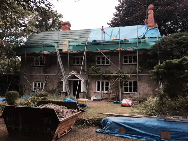a house with a blue tarpaulin
