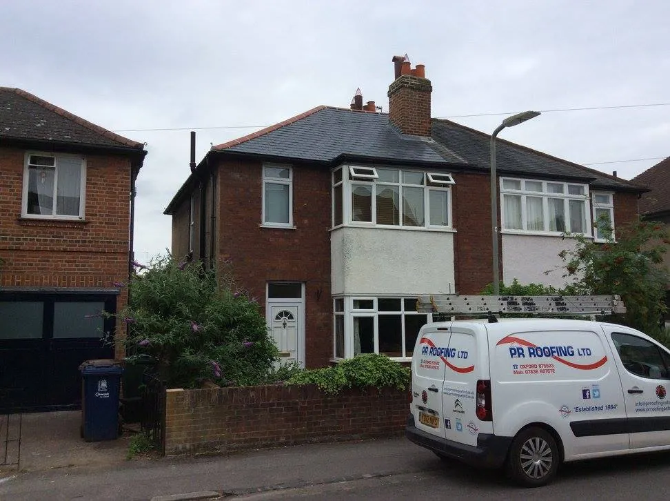 a white van parked in front of a house